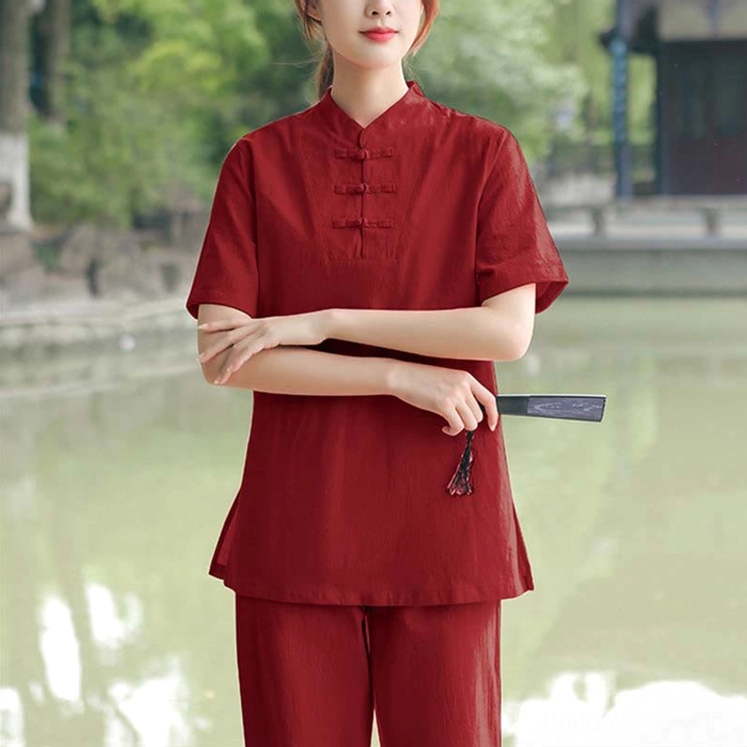 Burgundy red meditation and tai chi set full-body front view with stand collar and matching loose pants by waterside