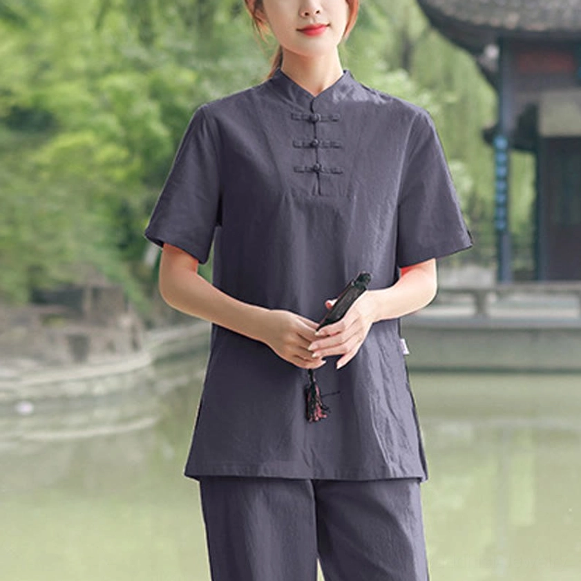 Dark grey cotton-linen tai chi set three-quarter front view with stand collar and matching loose pants in garden setting