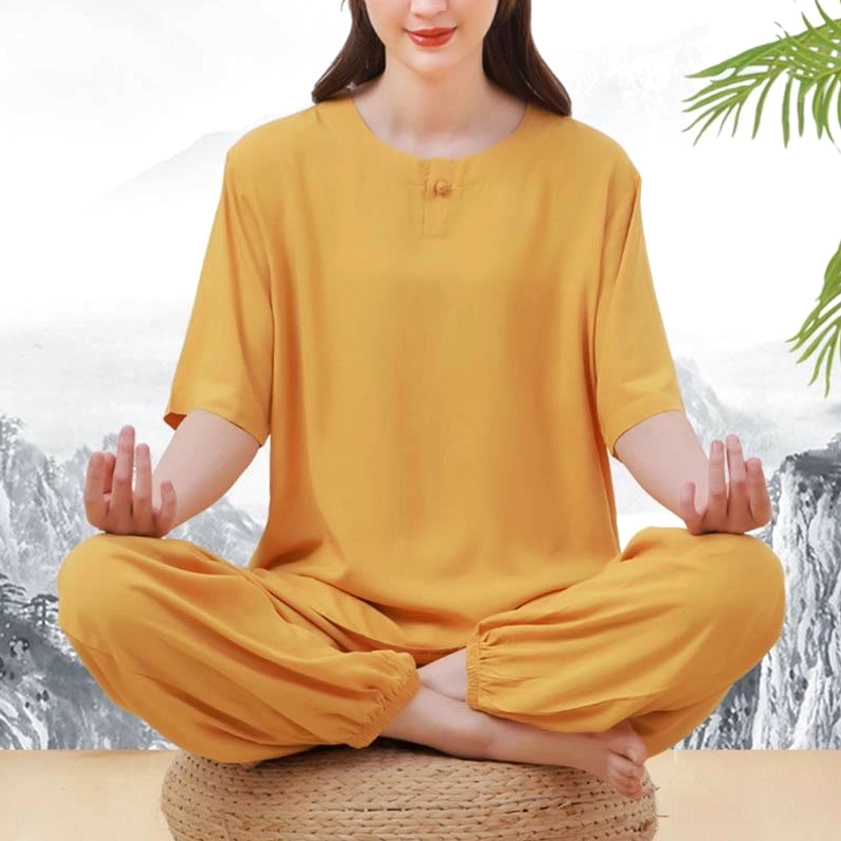 Yellow tai chi meditation clothing set cross-legged seated view showing frog button detail on crew neck and half sleeve design