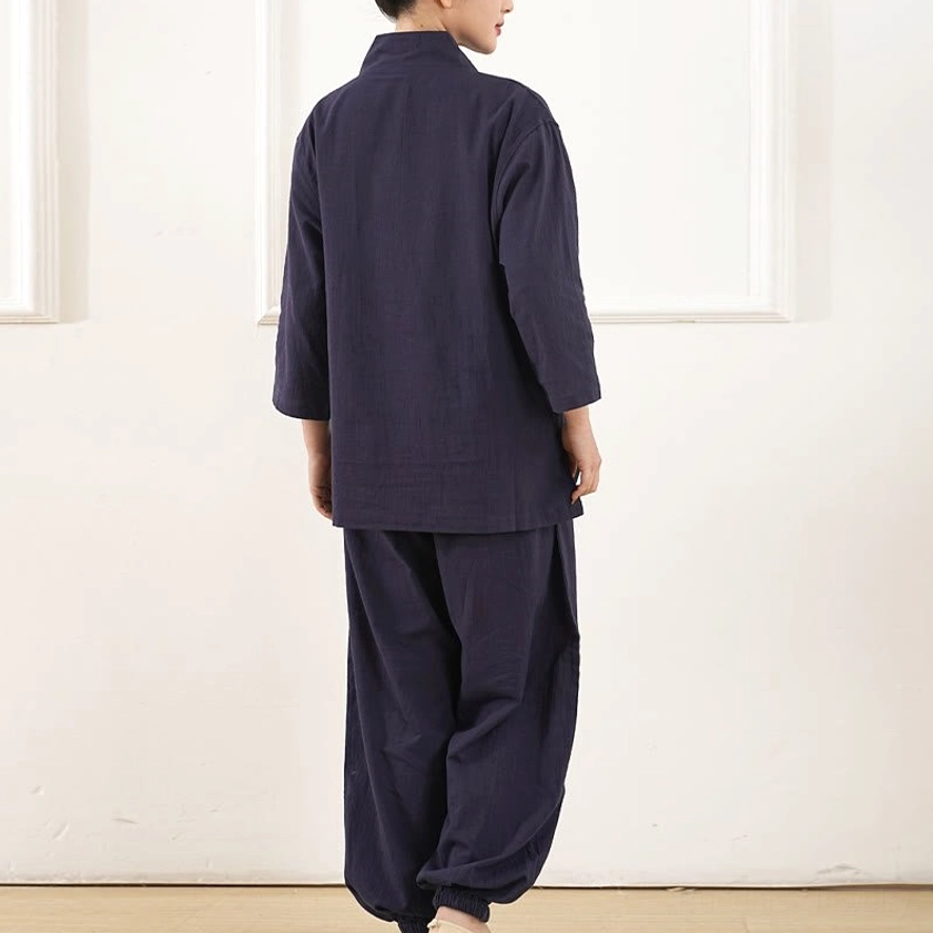 Detail view of white three-quarter sleeve v-neck meditation top with elastic waist pants