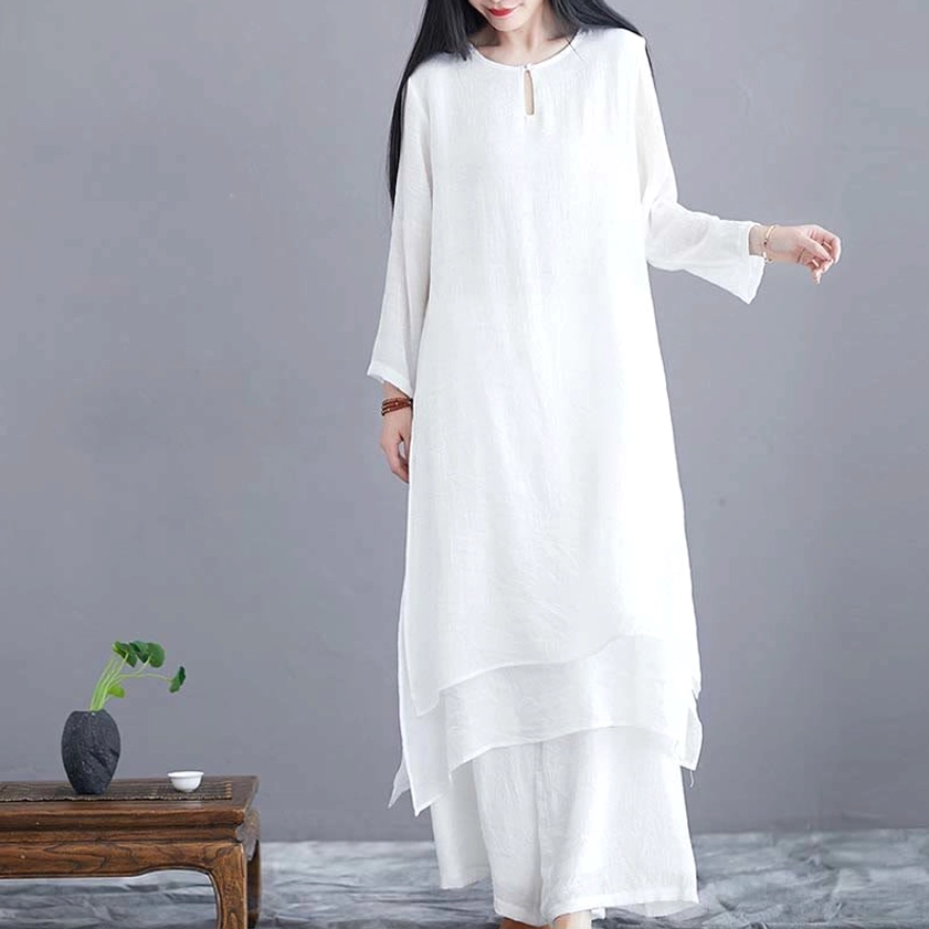 Front right angle view of solid white zen two-piece set with split side tunic design
