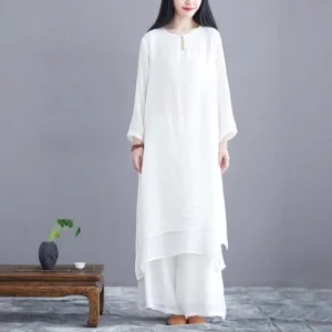 Women's white zen meditation two-piece set with layered tunic and wide-leg pants, front view on model