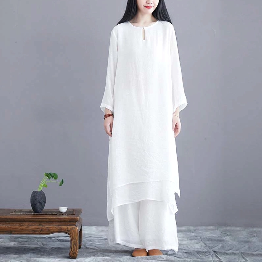 Women's white zen meditation two-piece set with layered tunic and wide-leg pants, front view on model