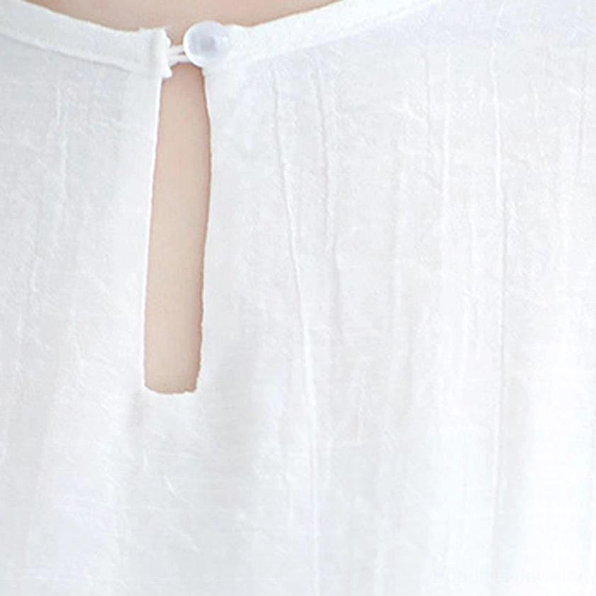 Detail view of white zen practice set highlighting tunic layers and wide-leg pants drape
