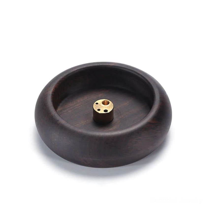 Dark wood incense holder flat lay with rounded edges and brass incense socket on white background