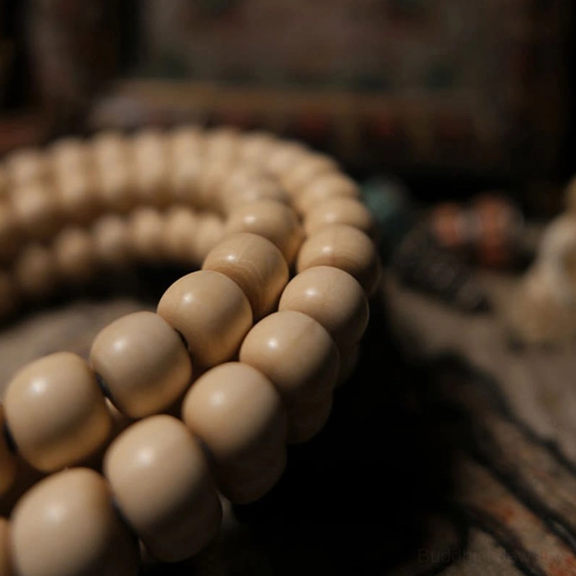 Close-up of plump beige Abelia Biflora barrel beads from Buddhist meditation mala bracelet