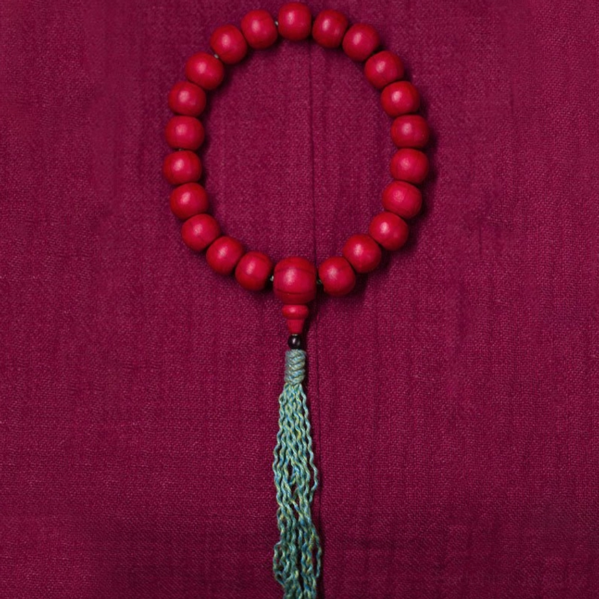 Handmade Abelia Biflora wooden mala beads flat lay showing complete circular prayer bracelet design