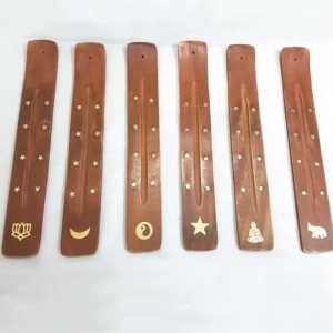 Handcrafted wooden incense holder with gold star inlay flat lay top view Buddhist decoration