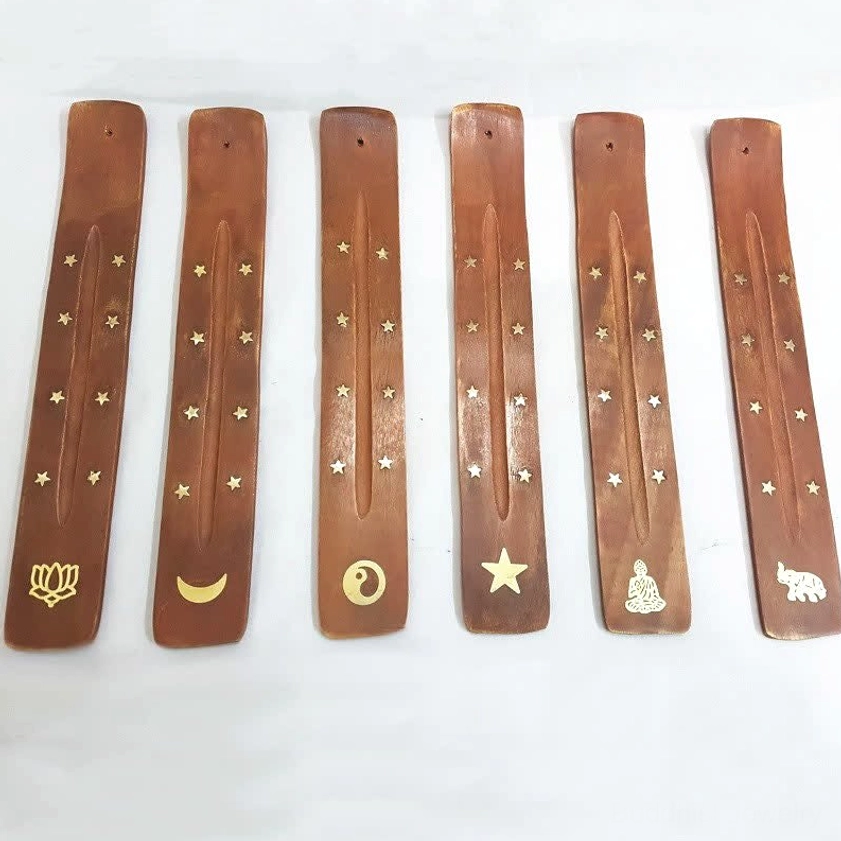 Handcrafted wooden incense holder with gold star inlay flat lay top view Buddhist decoration