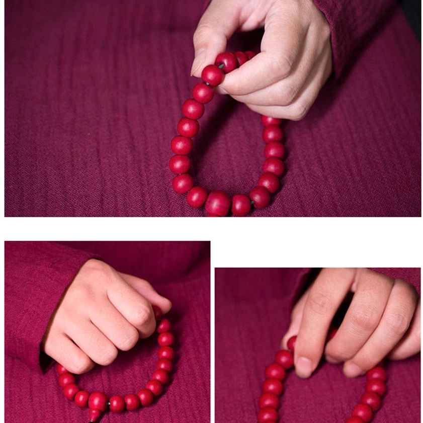 Uniform round Abelia Biflora wooden mala beads held in single hand showing bead pattern clarity