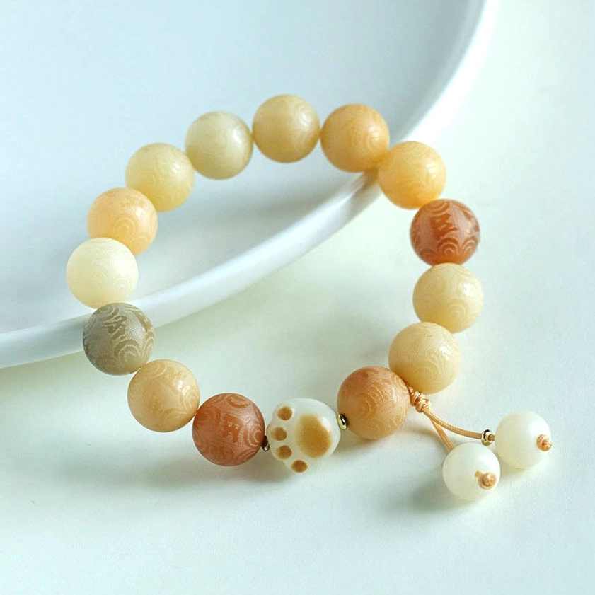 Yellow Bodhi Seed Buddhist bracelet with warm gradient tones and hand-tied tassel charm pendants