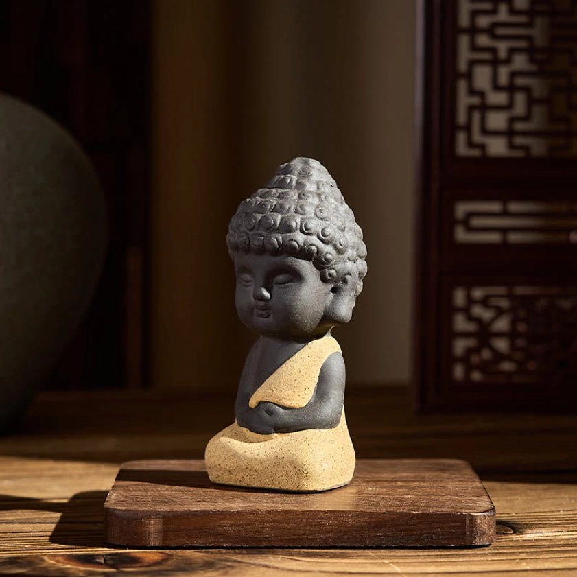 Yellow Buddha statue three-quarter side profile view, handcrafted purple clay serene meditation figurine