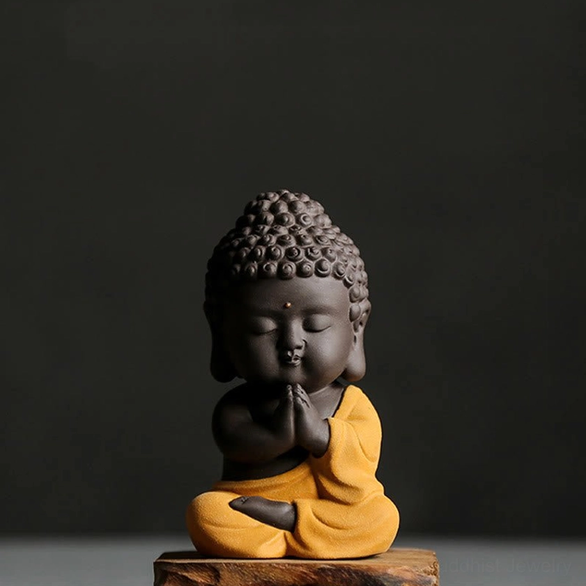 Yellow Buddha statue variant - handcrafted purple clay figurine with golden yellow robe, serene expression for spiritual home decor
