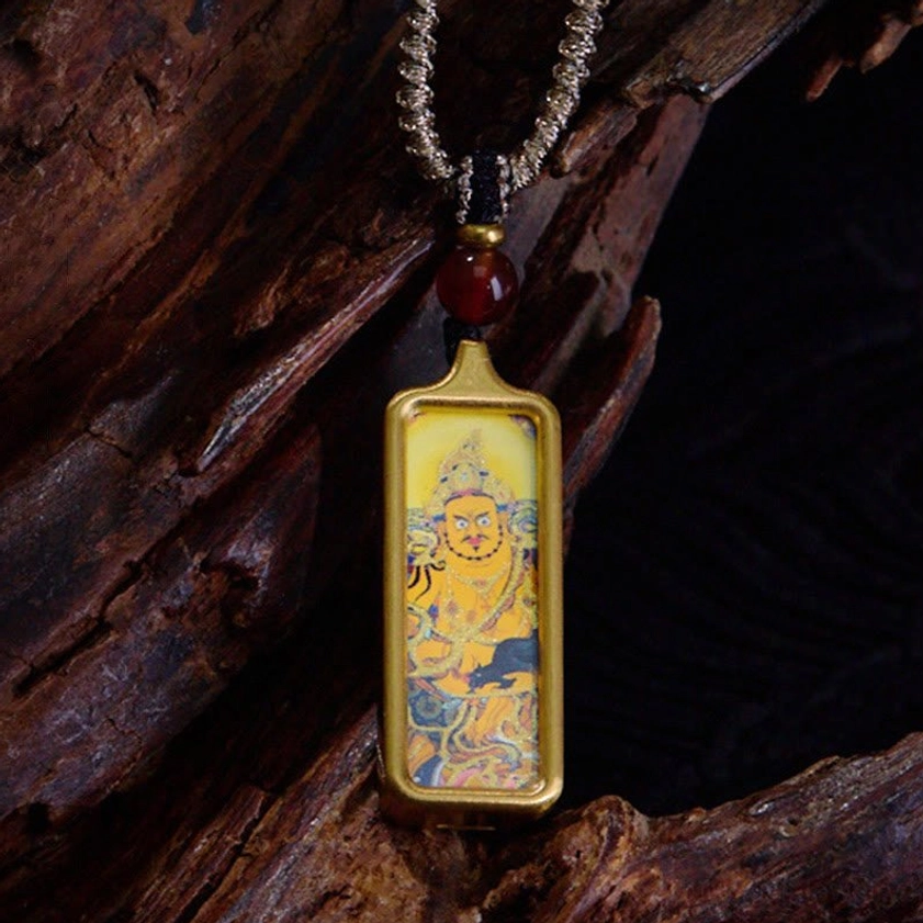 Yellow God of Wealth Buddhist thangka pendant necklace with gold frame, red agate bead, twisted silver cord and prosperity deity artwork