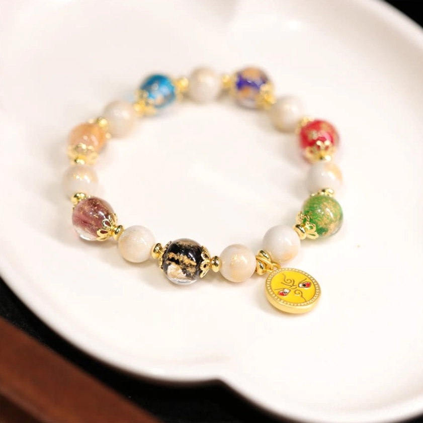 Yellow God of Wealth Buddhist bracelet with smiley face charm, mixed color beads and gold metal accents