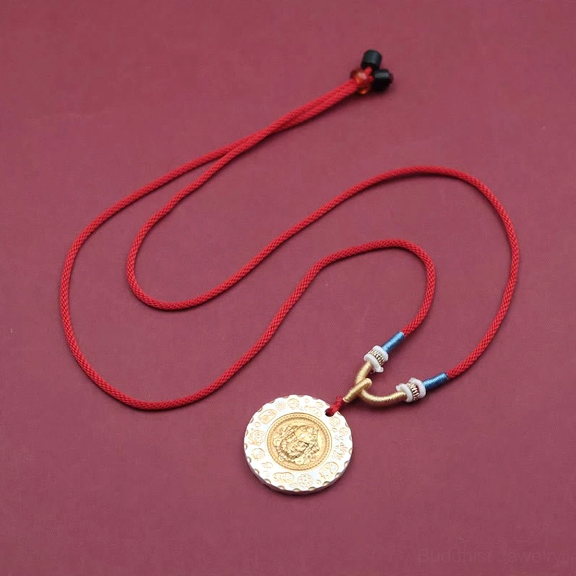 Full length Yellow Jambhala necklace with adjustable black rope clasp and 18 inch length displayed on wine red background