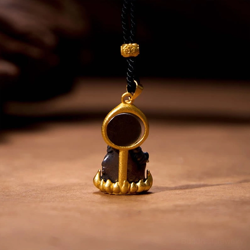 Back view of Yellow Jambhala Buddha pendant showing gold metal frame and flat back plate