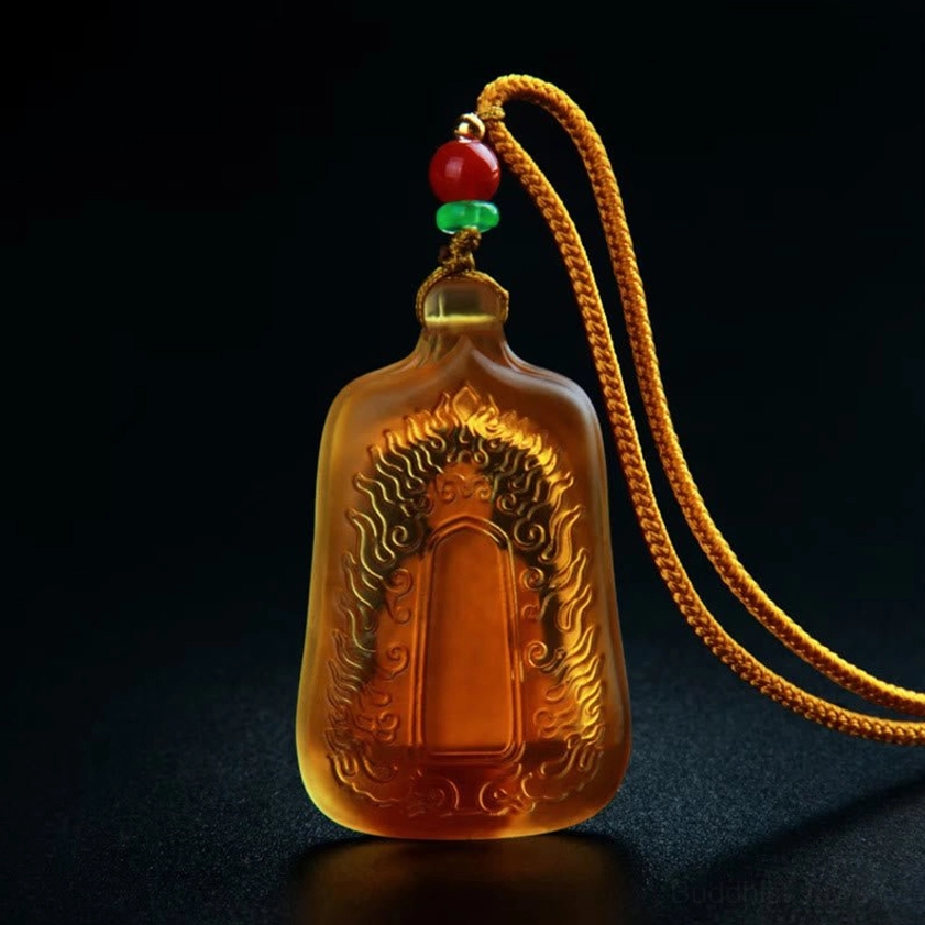 Yellow Medicine Buddha Liuli crystal pendant with chain attachment showing frosted glass and gold Buddha design