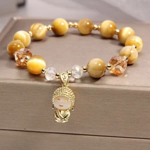 Yellow tiger eye meditation Buddha protection bracelet with gilded Buddha pendant on gray jewelry box