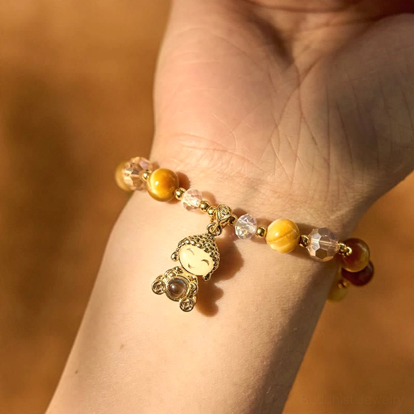 Yellow tiger eye Buddha protection bracelet with faceted crystal beads and gold metal charm for spiritual practice