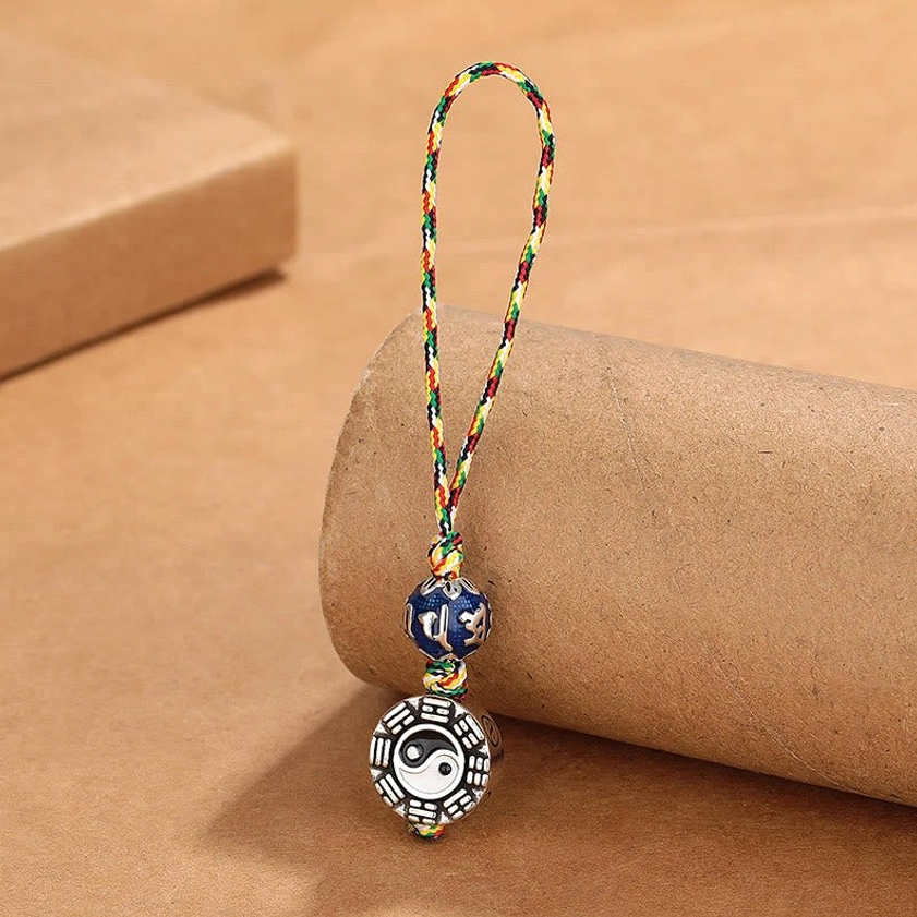 Copper Yin Yang Bagua Om Mani Padme Hum keychain with colorful braided rope and blue enamel mantra bead, left front view