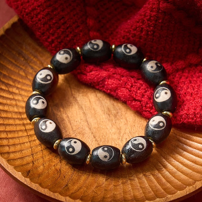 Yin yang dzi bead bracelet packaging product shot showing handcrafted buddhist amulet jewelry presentation