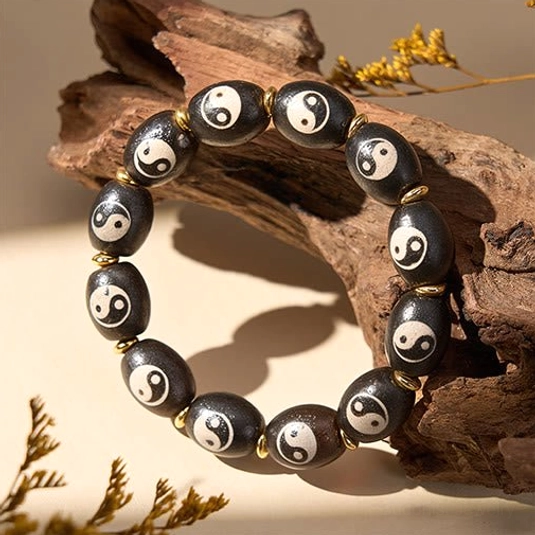 Yin yang agate dzi bead bracelet multiple angle detail view showcasing hand-painted patterns and artisan quality