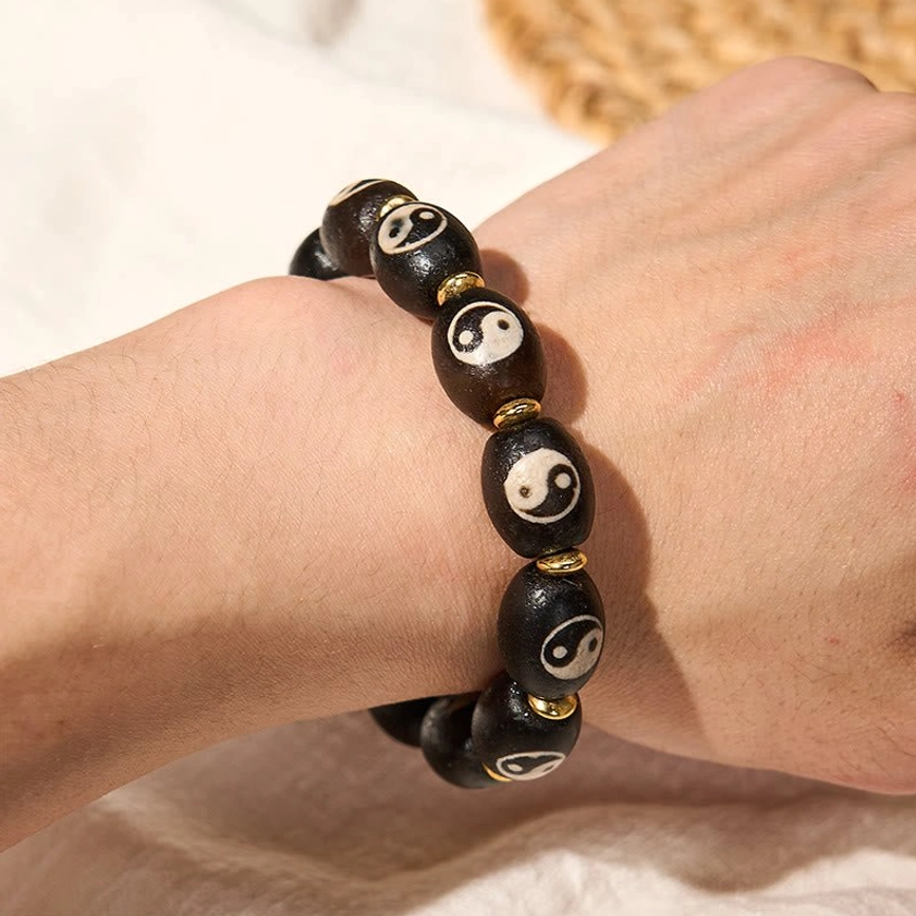 Yin yang dzi bead bracelet styled lifestyle image showing how to integrate buddhist protective bracelet into wellness routine
