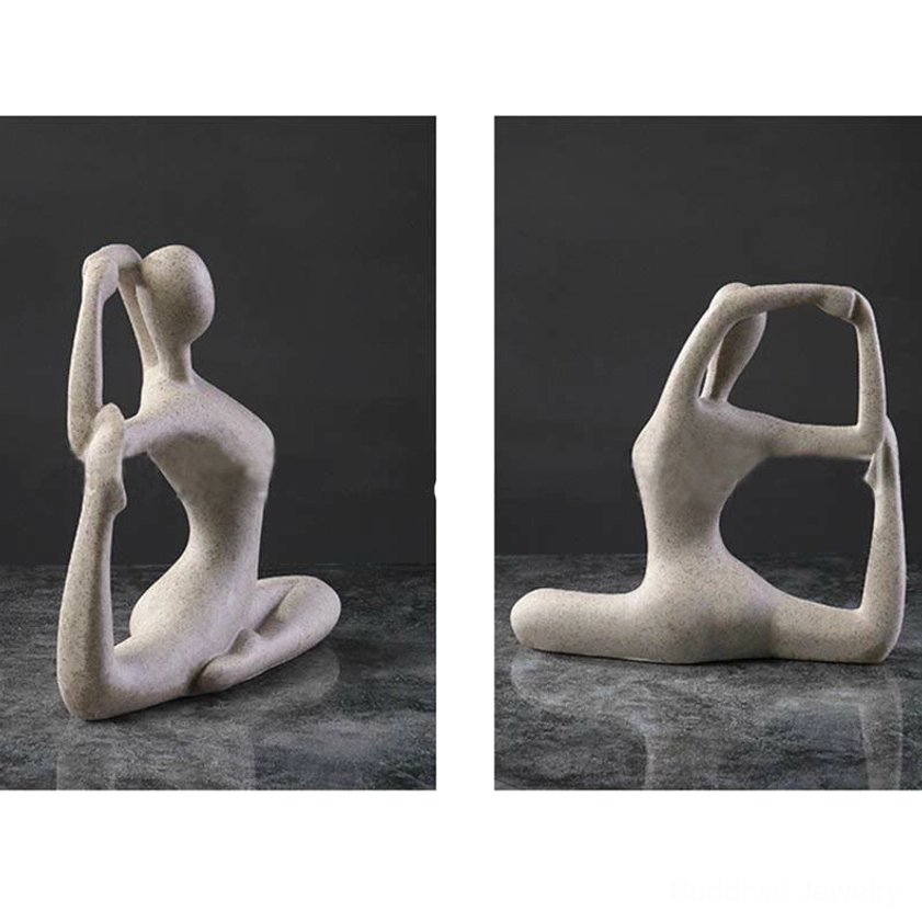 Single abstract yoga back stretch meditation figurine in beige speckled resin on dark marble desk with gray backdrop