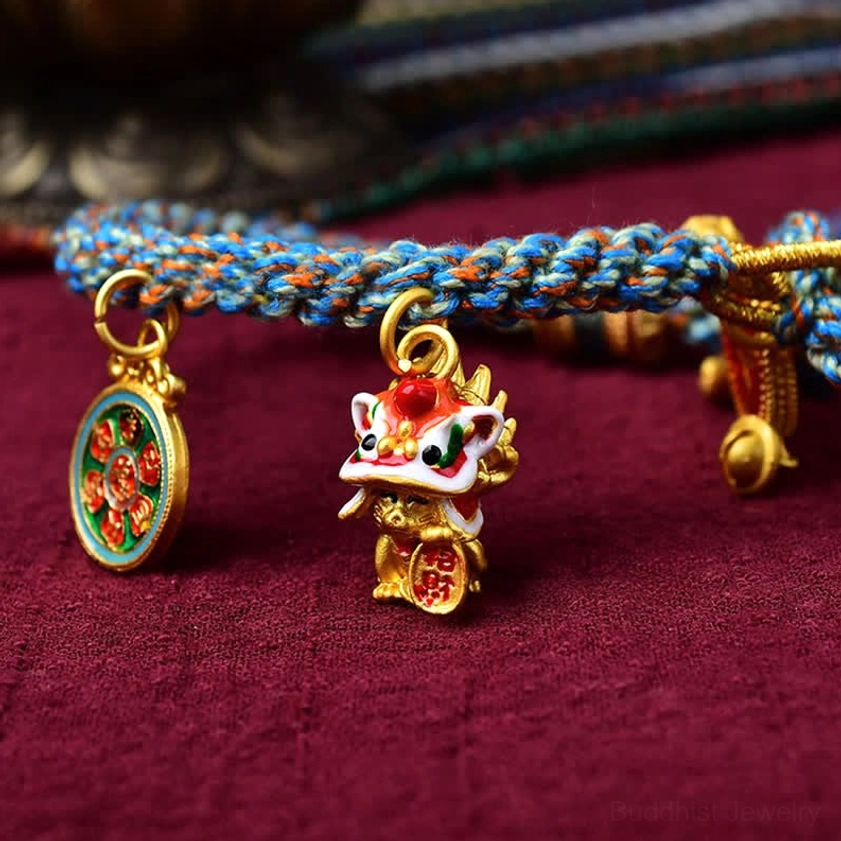 Close-up detail of Zakiram Buddhist blessing bracelet highlighting enamel pendants and braided rope craftsmanship