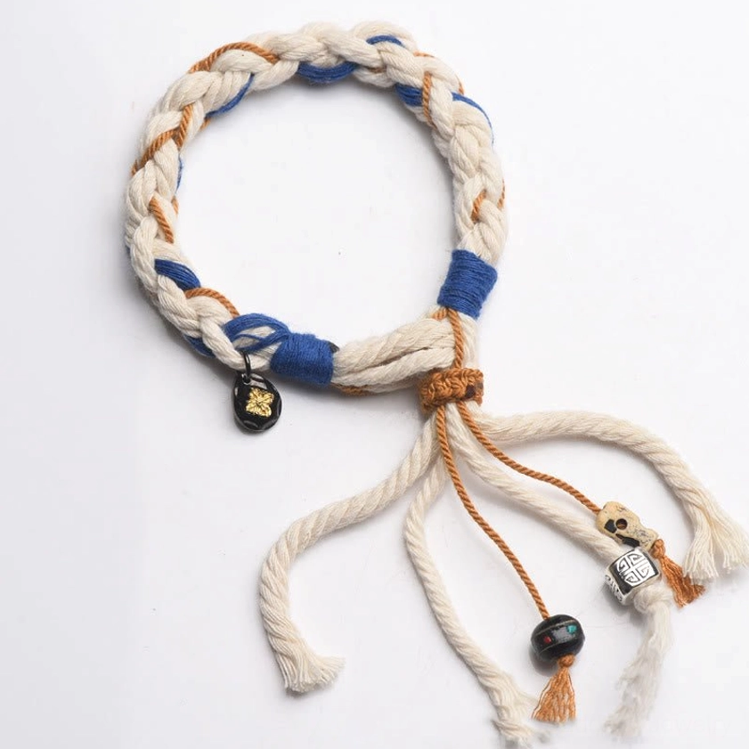 Close-up texture of Zakiram bracelet natural cotton materials showing handmade quality and authentic Buddhist craftsmanship details