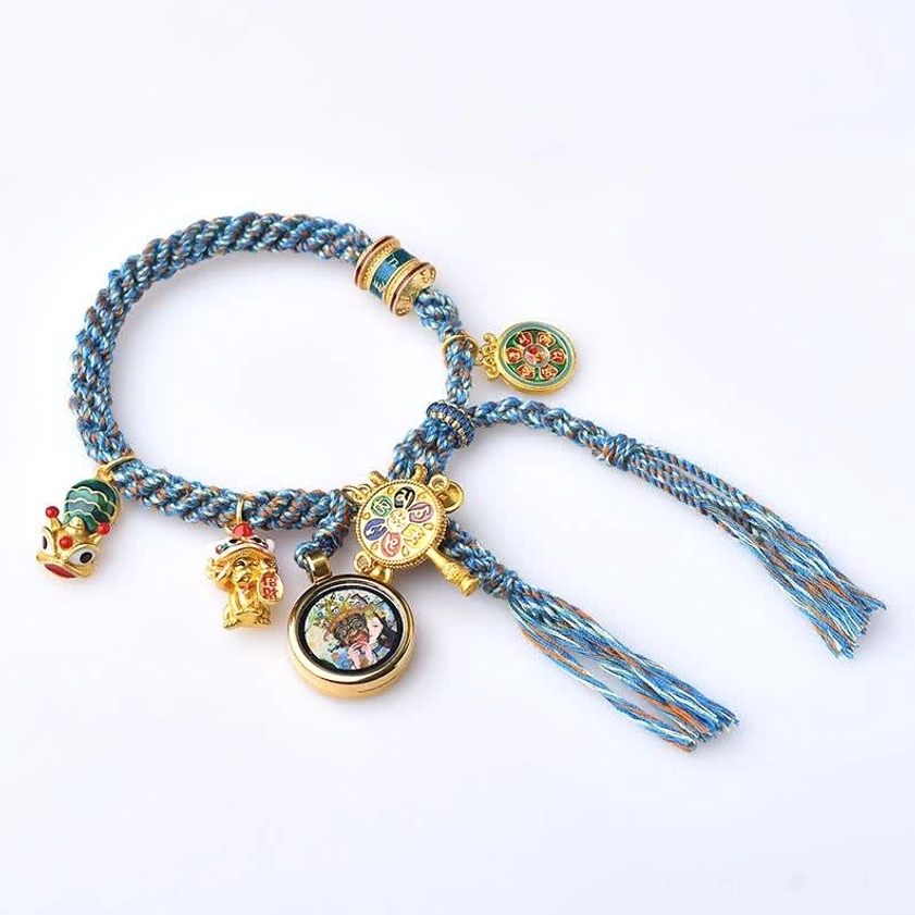 Zakiram Goddess of Wealth Buddhist string bracelet with blue braided cord and multiple spiritual charms on white background