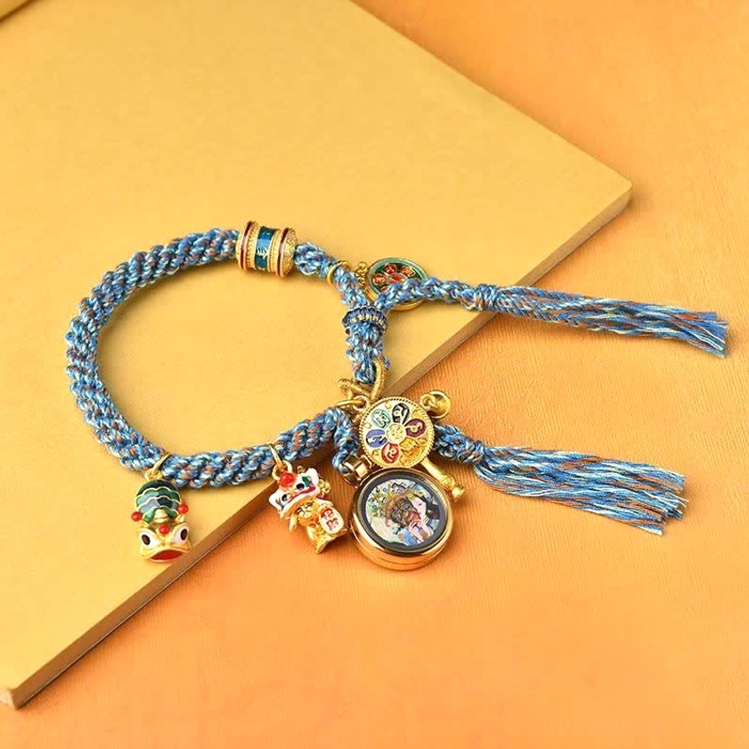 Handmade Buddhist Zakiram bracelet with lion dance charm and round enamel pendants on blue braided cord