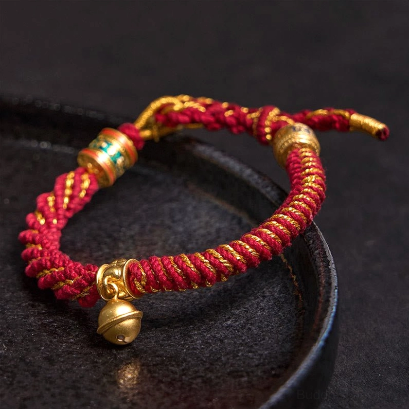 Zakiram goddess of wealth protective bracelet with bell charm and woven cord for spiritual protection and prosperity