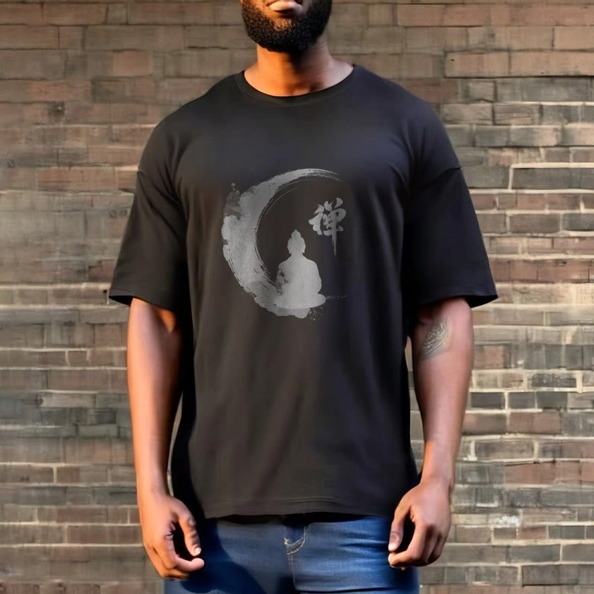 Charcoal dark grey Zen Buddha meditation t-shirt on male model with brick wall backdrop, demonstrating the light ink-wash Buddhist graphic on darker fabric
