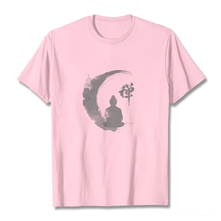 Light pink Zen Buddha meditation t-shirt flat lay front view on pastel pink background, showing the grey ink-wash crescent moon and Buddha design