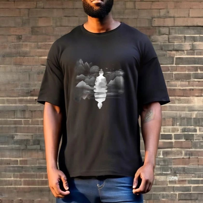 Man wearing black Buddhist spiritual t-shirt with meditative Buddha and misty mountain design