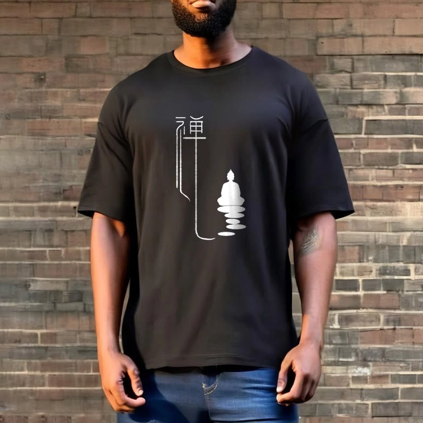 Zen buddha graphic tee black with white print worn by male model with blue jeans on brick wall