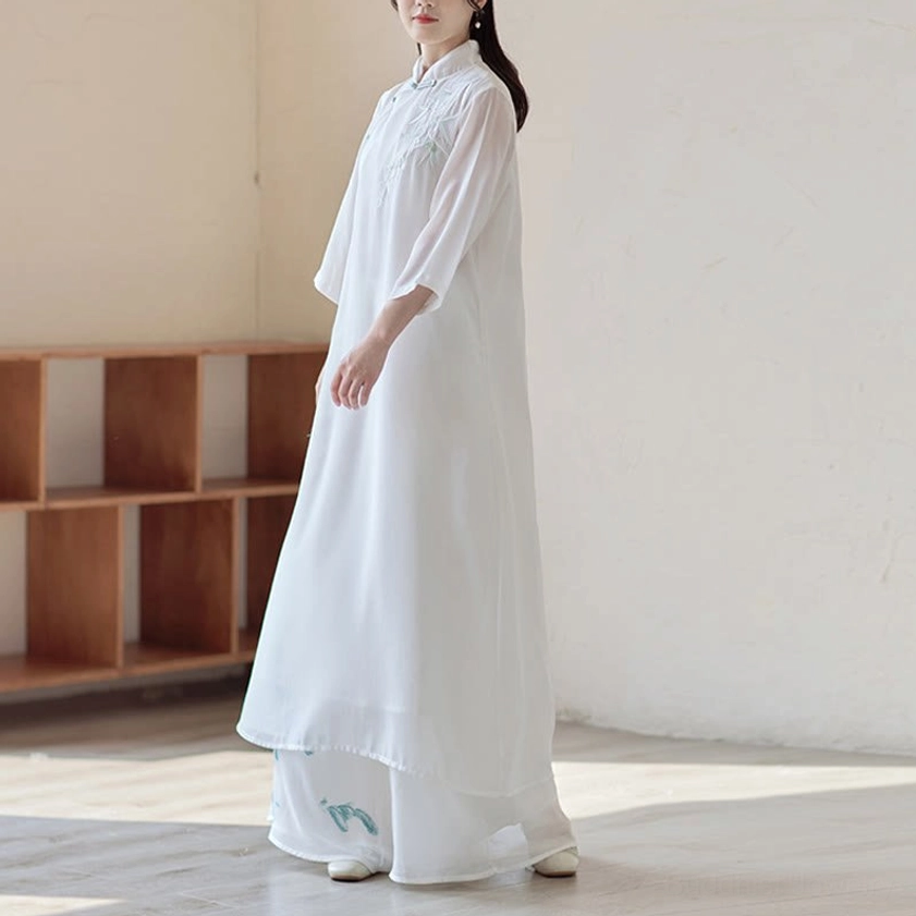 Zen spiritual practice clothing set featuring plain white sheer cheongsam dress and wide leg pants with subtle blue floral embroidery, side view