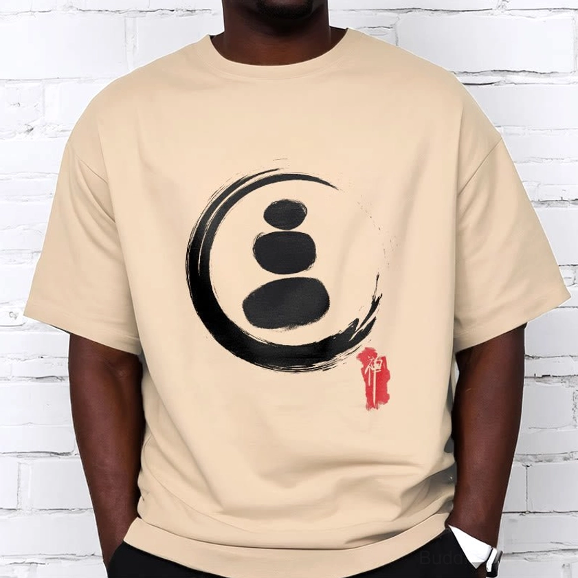 Light beige zen circles Buddhist graphic tee standing upper body view worn against white brick wall