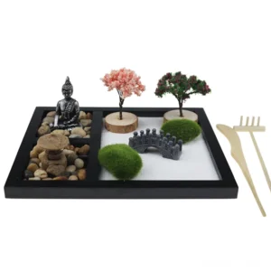 Handcrafted zen garden meditation kit with Buddha statue, Enso circle, decorative trees, and wooden rake on white background