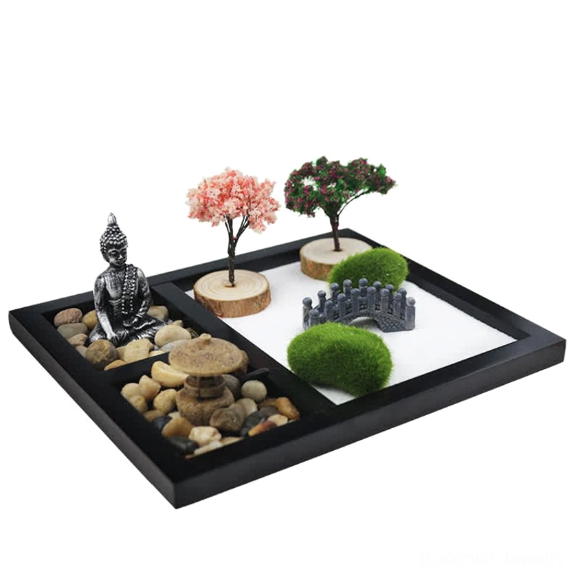 Zen meditation garden oblique view showing white sand, mini stone bridge, moss decor, and Buddha symbol
