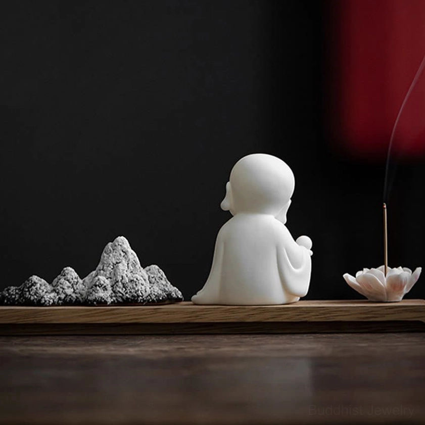 Zen incense holder with Buddha figurine and lotus flower design for spiritual practice and home decor