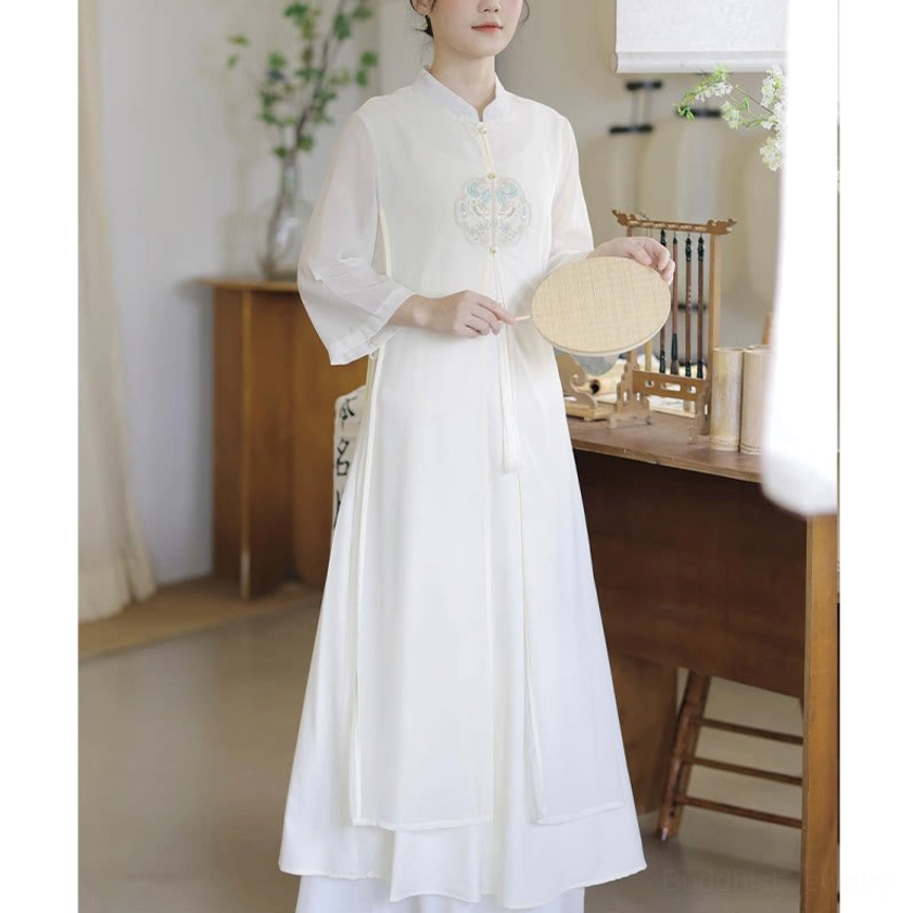 Off-white Zen meditation dress with embroidered round chest motif, front three-quarter view showing stand collar and breathable chiffon fabric