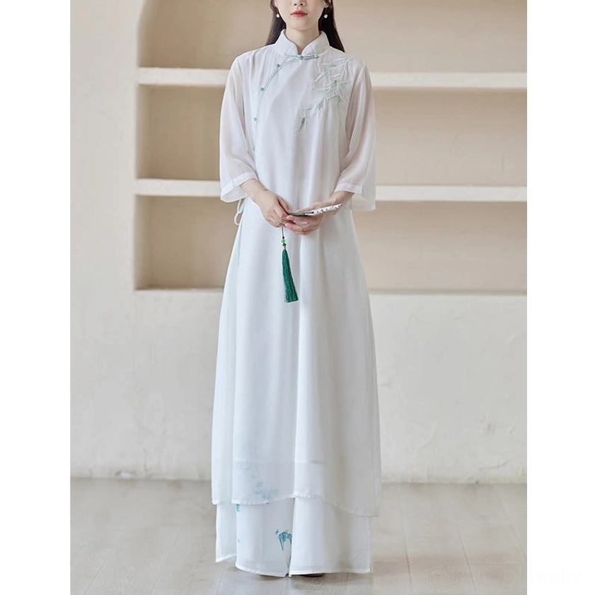 Zen meditation cheongsam dress and wide leg pants outfit, full-body front view with green tassel pendant and layered sheer dress hem details
