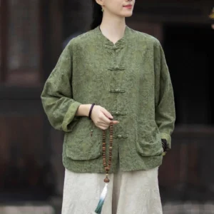 Women's olive green jacquard zen meditation shirt with frog buttons in ancient Chinese courtyard setting