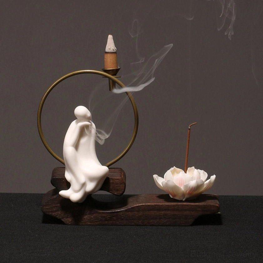 Contemplative monk incense burner with hand on chin and smoking tower incense, ceramic lotus holder for meditation