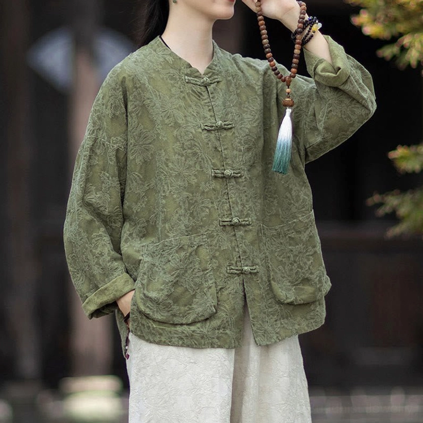 Three-quarter shot of women's zen meditation jacket with lifted sleeve showing craftsmanship and prayer beads