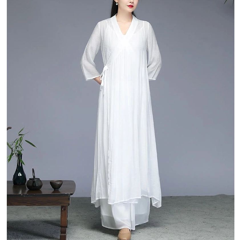 Woman wearing white Zen meditation outfit with hands in pockets showing comfort and ease of movement during spiritual practice