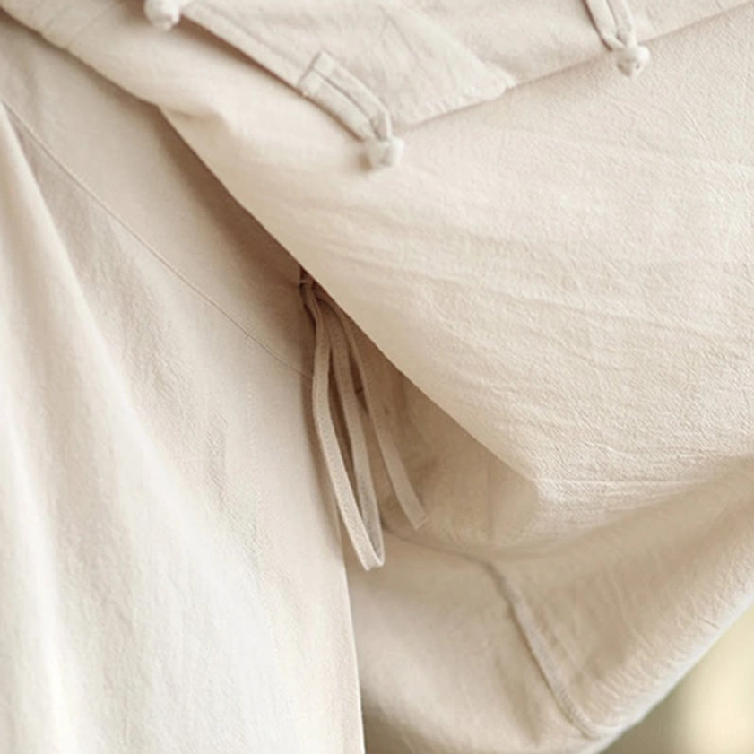 Zen meditation yoga practice wear close-up of fabric texture and v-neck design on women's beige linen cotton top